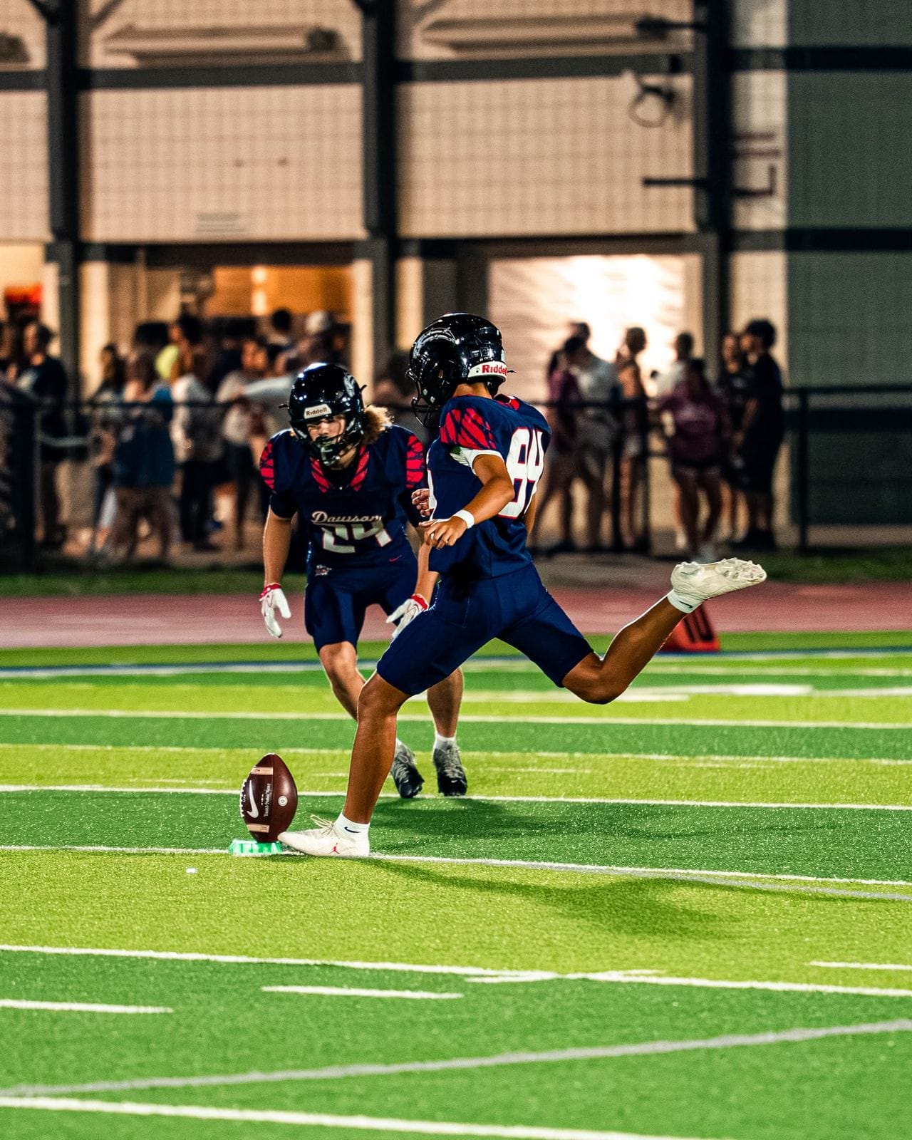 Oliver Abela, #84, kicking off for the Dawson Eagles